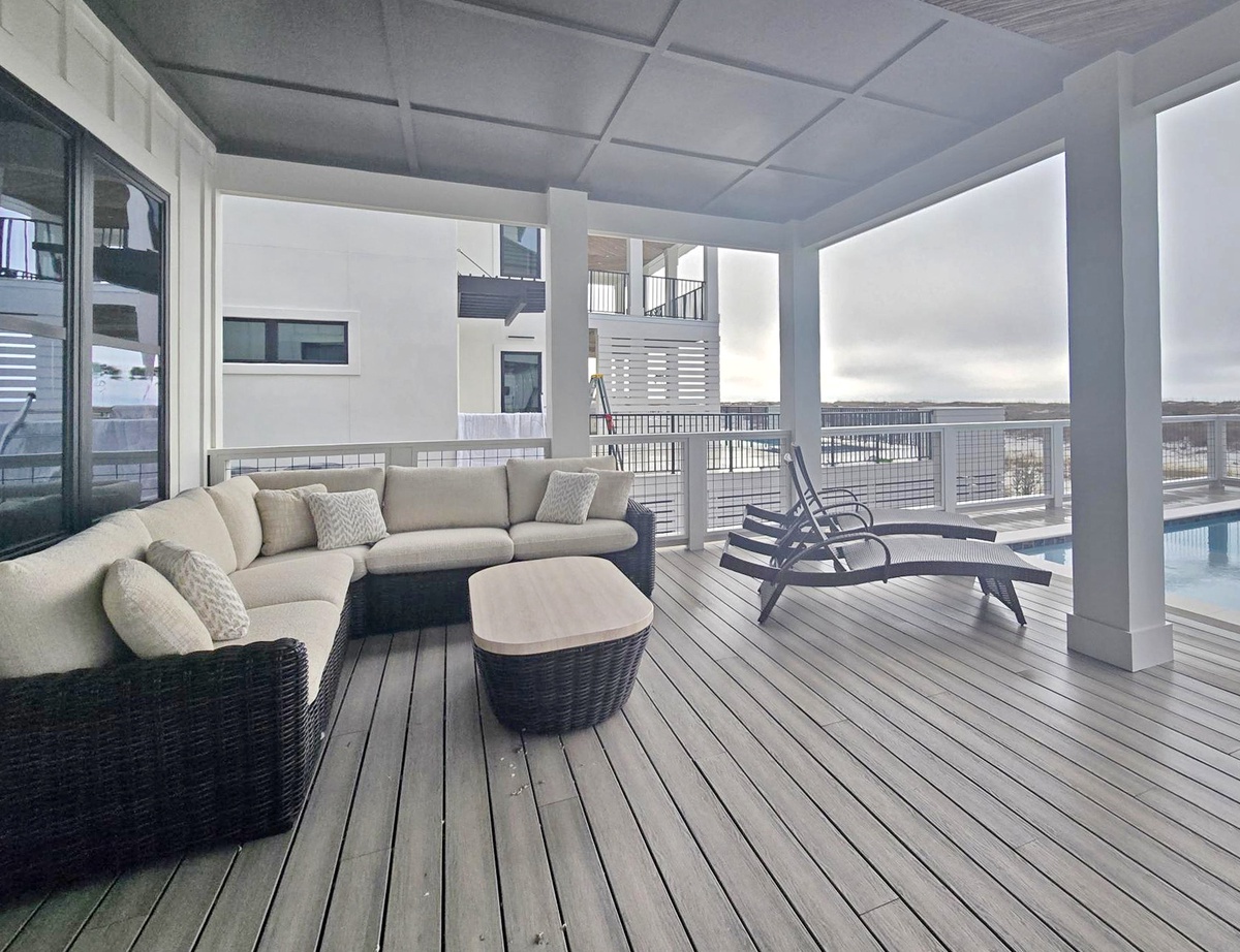 Sink into this plush sectional on your private covered terrace, where panoramic city views create the perfect backdrop for morning coffee or evening relaxation.