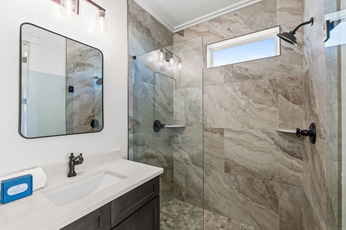Step into your luxurious bathroom with stunning marble-look tile walls, a spacious walk-in shower, and elegant fixtures that make every morning feel like a spa retreat.