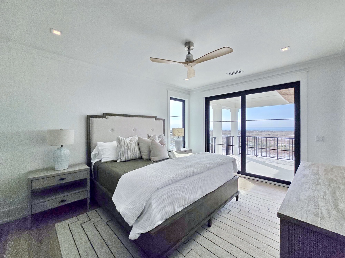 Wake up to stunning views from your private balcony in this serene bedroom, where crisp linens and modern comfort create the perfect retreat.