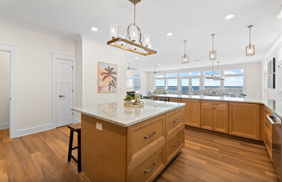 Your gourmet kitchen features marble countertops, modern appliances, and stunning water views to inspire your culinary adventures.