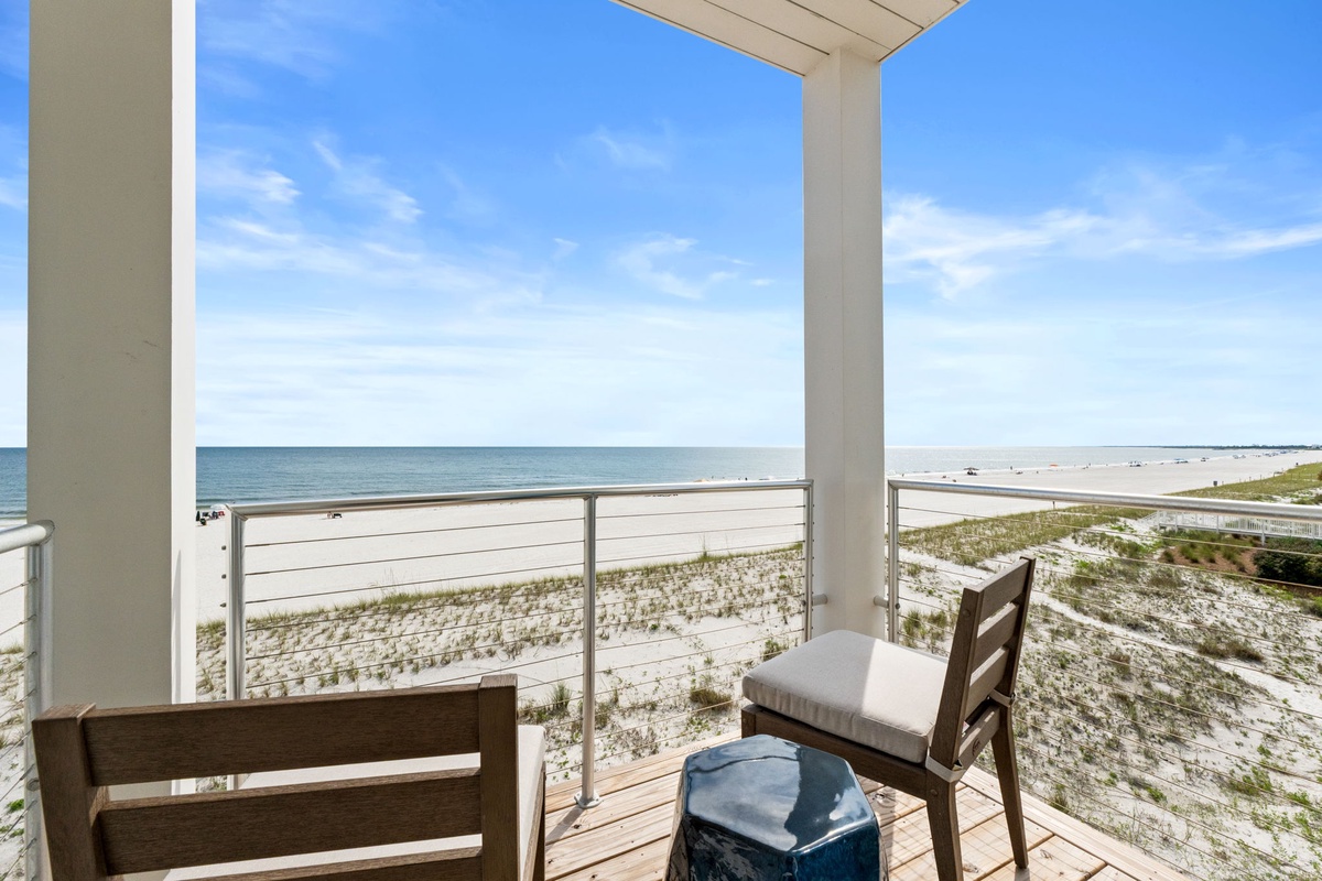 Relax on your private covered balcony with stunning beachfront views. Feel the coastal breeze while watching waves lap the shore, enjoying direct access to white sandy beaches just steps away.