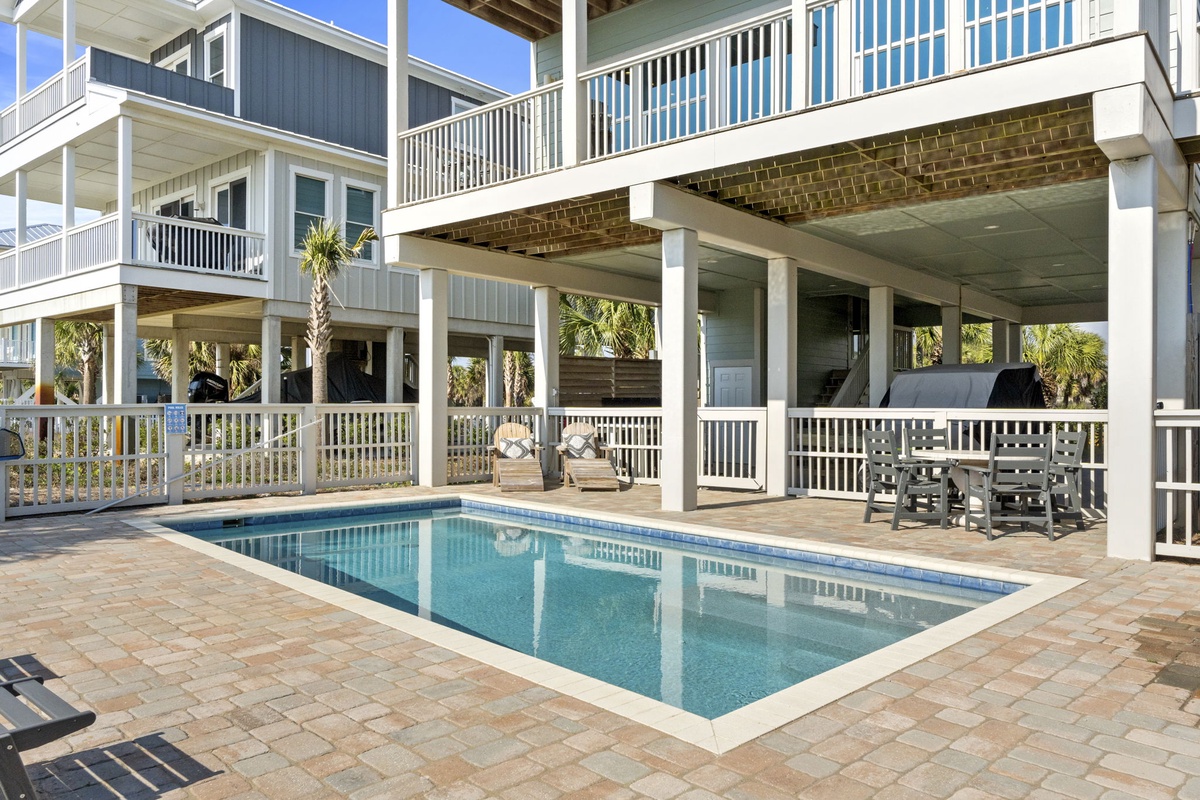 Your private pool awaits beneath tropical palms, with covered dining perfect for sunset meals and loungers for afternoon relaxation.