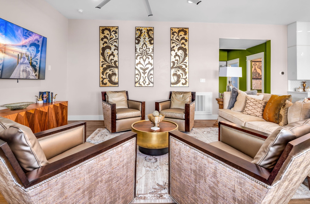 Sink into plush leather seating surrounded by curated artwork and warm wood accents for your perfect relaxation retreat.