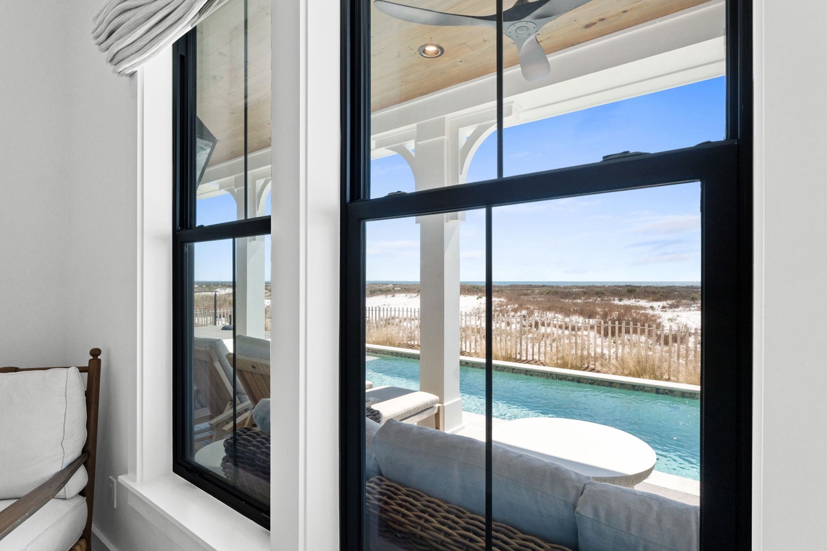 Gaze through your window at stunning pool views and endless blue skies, where modern comfort meets serene outdoor beauty.