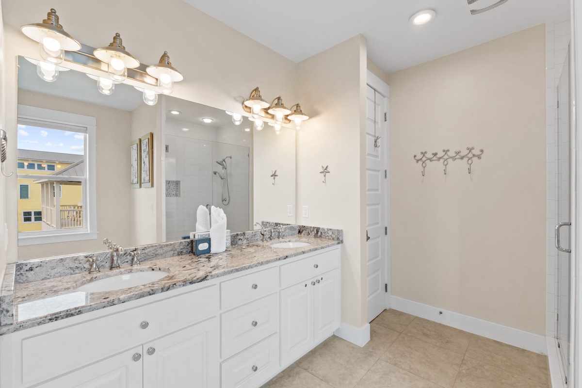Step into your elegant master bathroom with dual vanities, granite countertops, and spacious walk-in shower for ultimate luxury.