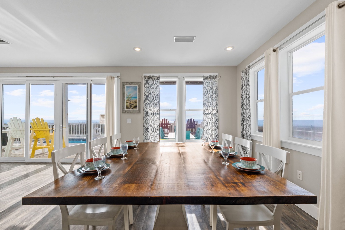 Share memorable meals at your elegant dining table with panoramic ocean views through floor-to-ceiling windows.