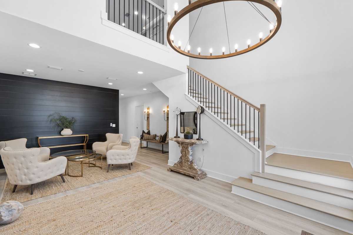 Step into your elegant living space where soaring ceilings and sophisticated design create the perfect atmosphere for relaxation and memorable conversations.