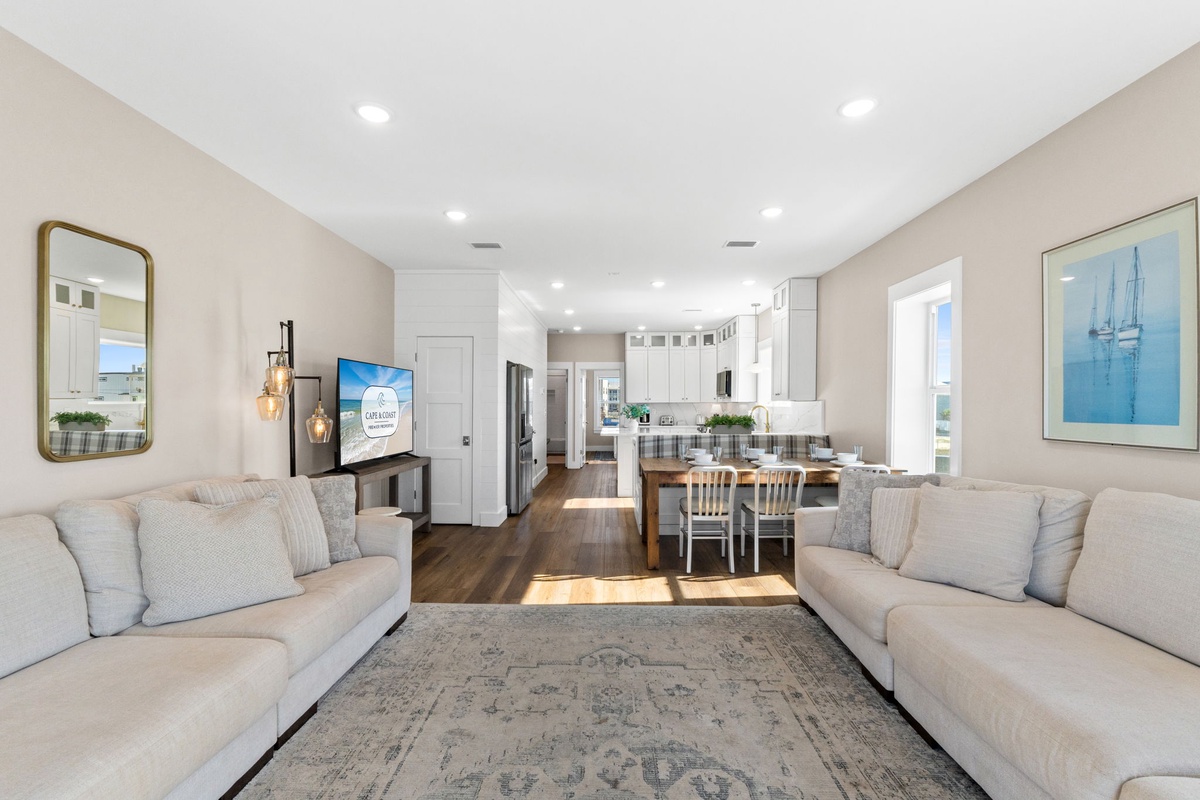 Relax in this bright, open living space with comfortable seating flowing seamlessly into your fully equipped kitchen and dining area.