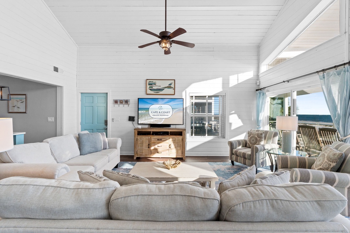 Sink into plush sofas and unwind in this bright coastal living room where ocean views and nautical touches create your perfect seaside retreat.