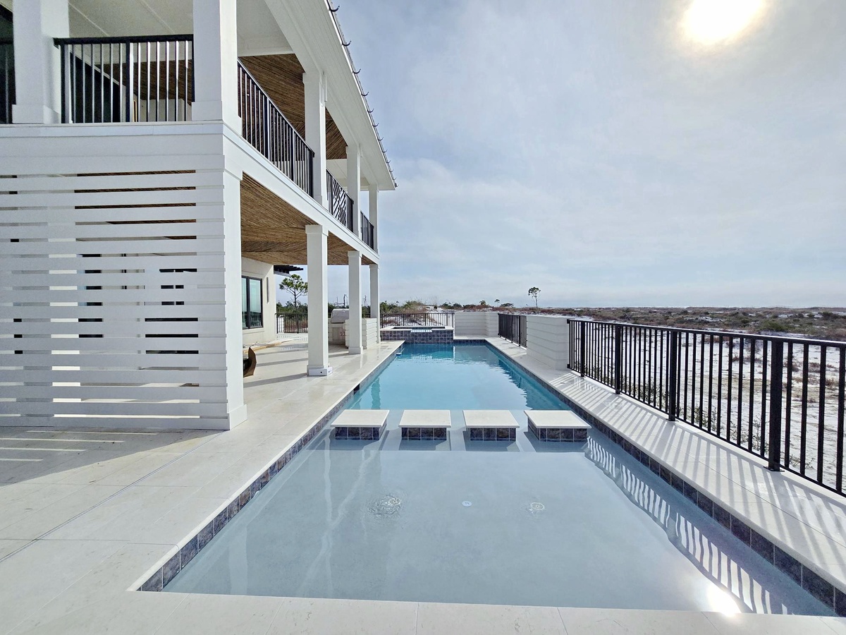 Dive into your private oasis with this stunning rooftop pool, offering refreshing swims and breathtaking panoramic views stretching to the horizon.