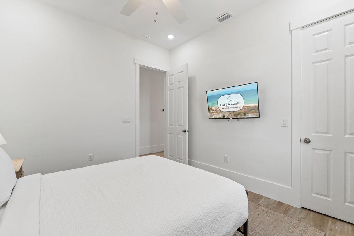 Unwind in your bright, airy bedroom with crisp linens and wall-mounted TV for cozy nights in.