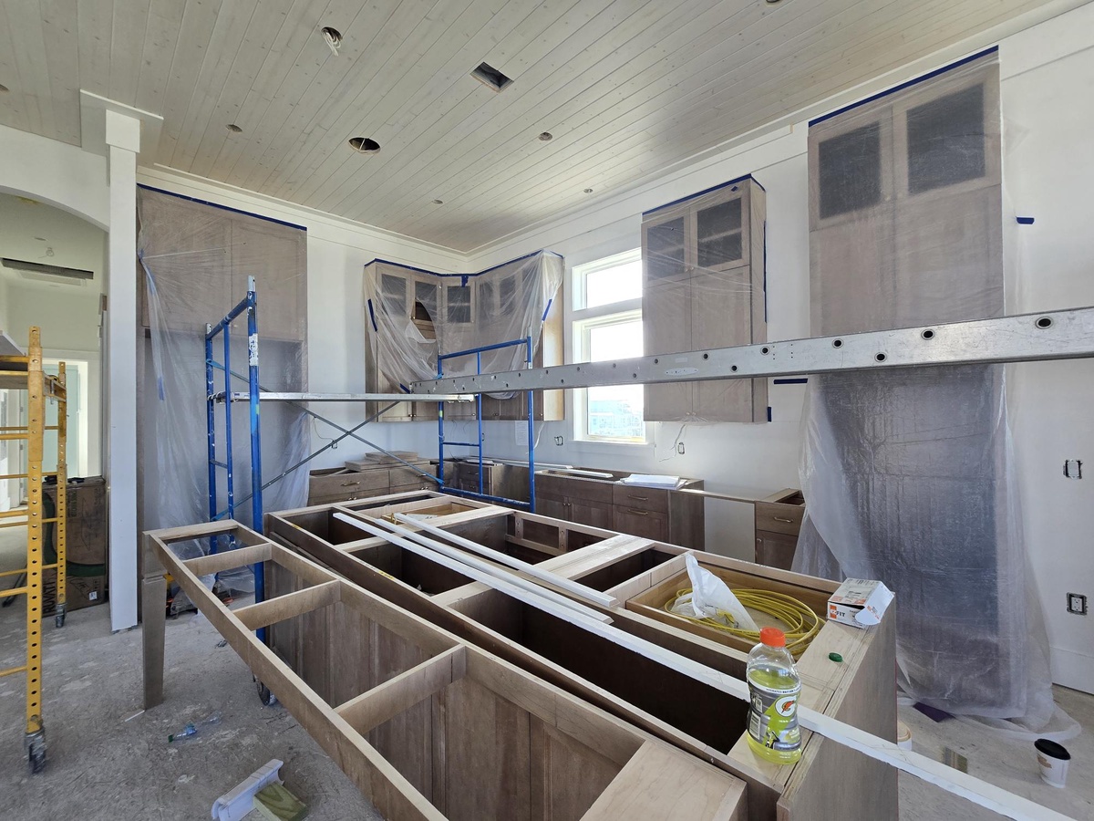 A modern kitchen taking shape with custom cabinetry and contemporary finishes, part of the property's thoughtful design and construction.