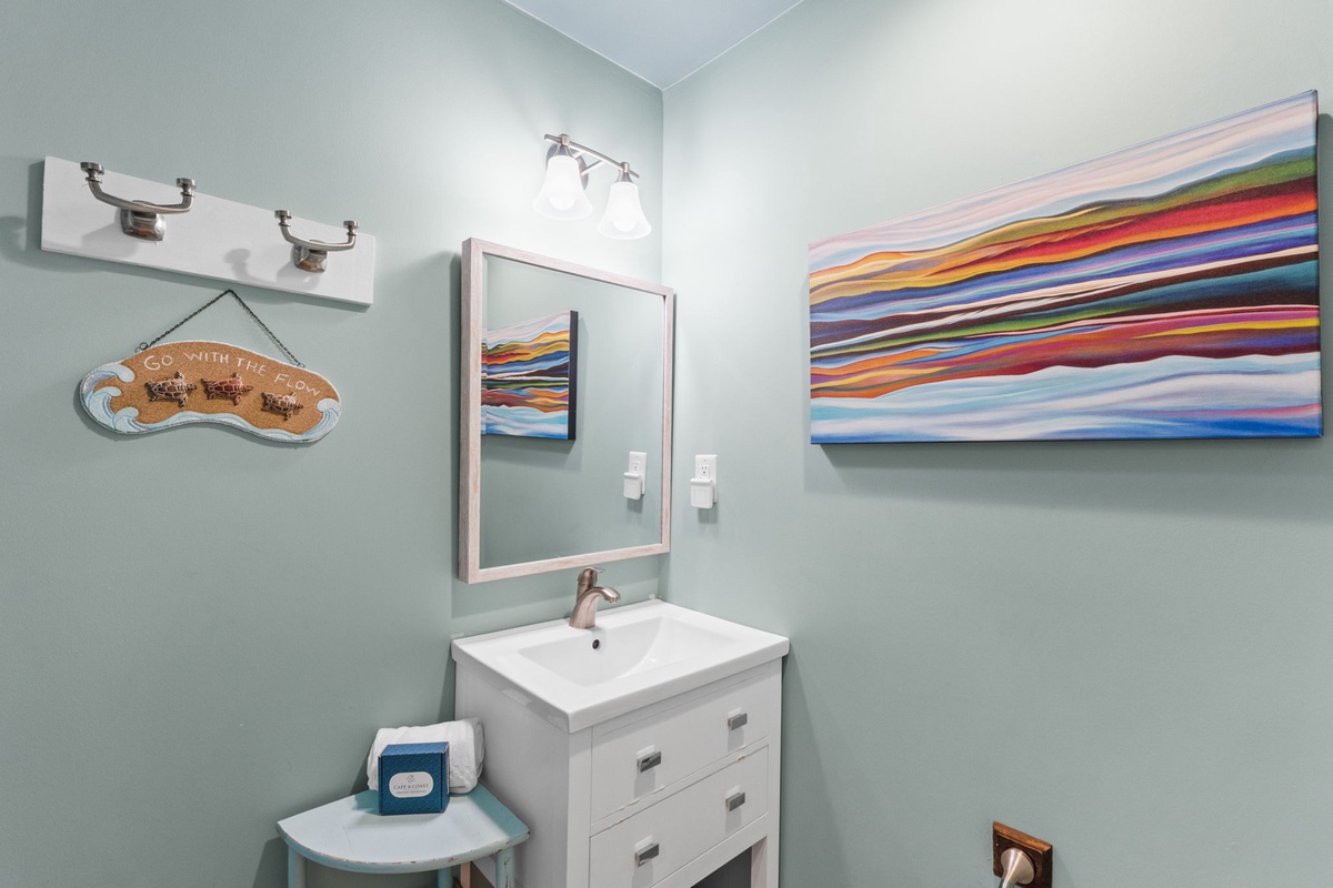 Step into your bright, cheerfully styled bathroom where soothing coastal tones and thoughtful details await. The crisp vanity and soft lighting create a refreshing space to start your day.