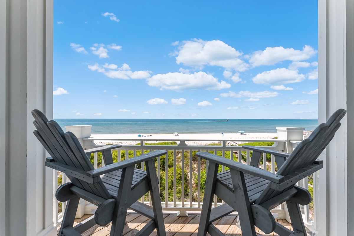Step onto your private balcony where two Adirondack chairs await your morning coffee as you gaze across pristine turquoise waters.