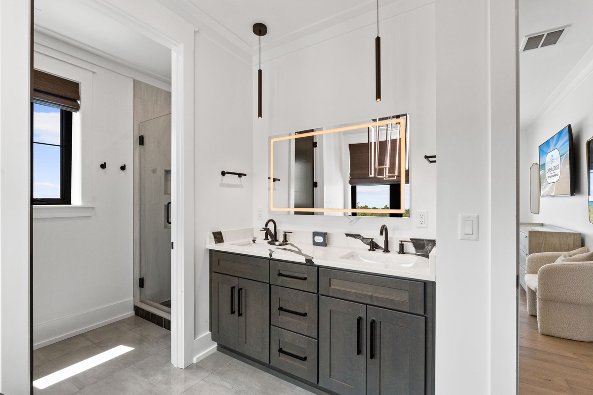 Freshen up in your modern bathroom with double vanity and sleek fixtures, bathed in natural light for a bright, welcoming start to your day.