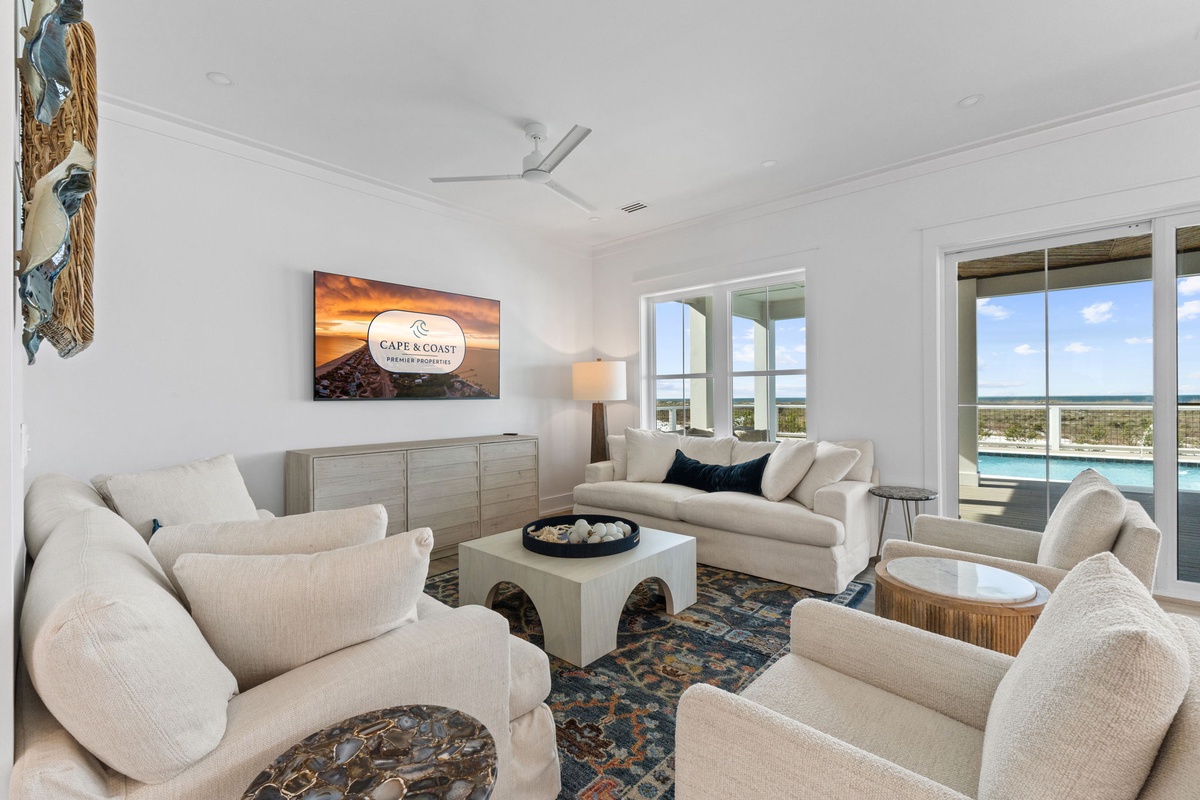 Relax in this elegant living room with plush seating, stunning views, and modern comfort for your perfect getaway.