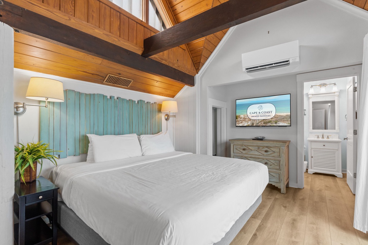 Drift off under soaring wood-beamed ceilings in your coastal-chic bedroom, complete with soothing tones, soft linens, and your own ensuite bathroom just steps away.