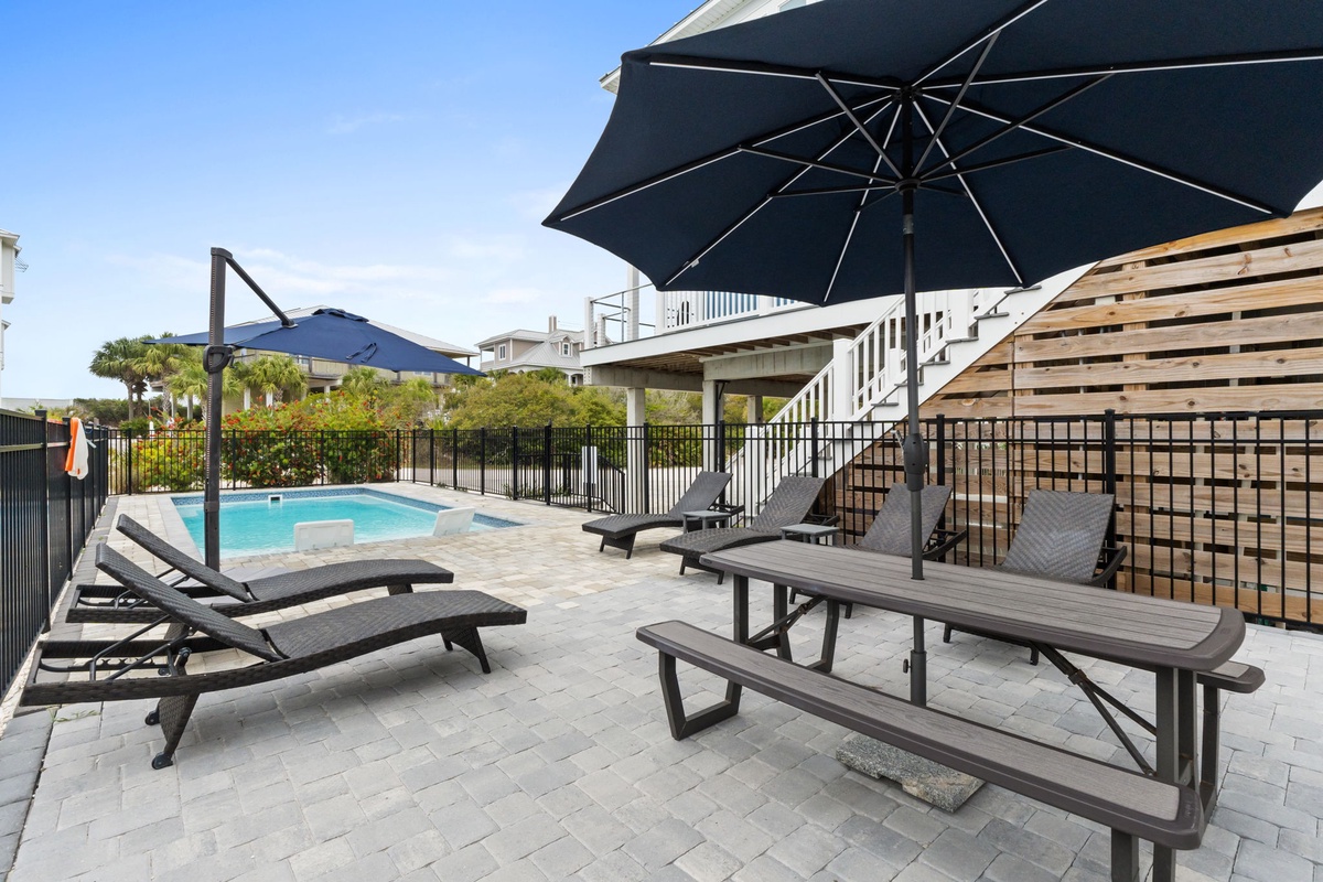 Soak up the sun on your private pool deck with comfortable loungers and shaded seating—perfect for poolside relaxation.