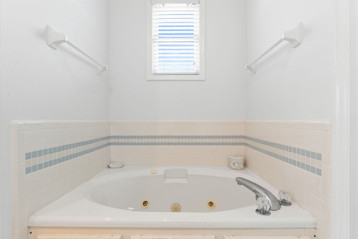 Sink into pure relaxation in your private jetted tub, complete with elegant tile accents and peaceful natural light.