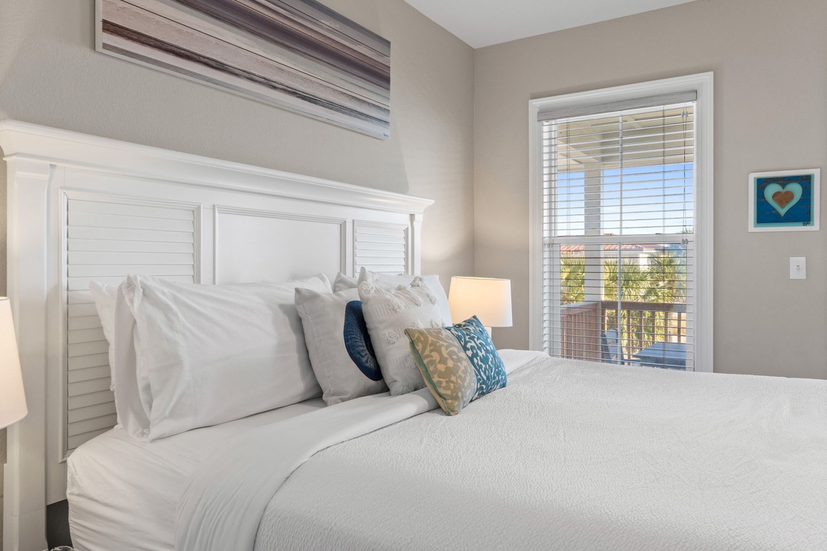 Drift off in your serene bedroom, where crisp white linens and coastal accents create perfect tranquility.