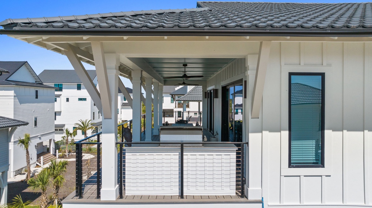 The property sits in a residential neighborhood with nearby homes, offering a peaceful coastal community setting for your vacation stay.