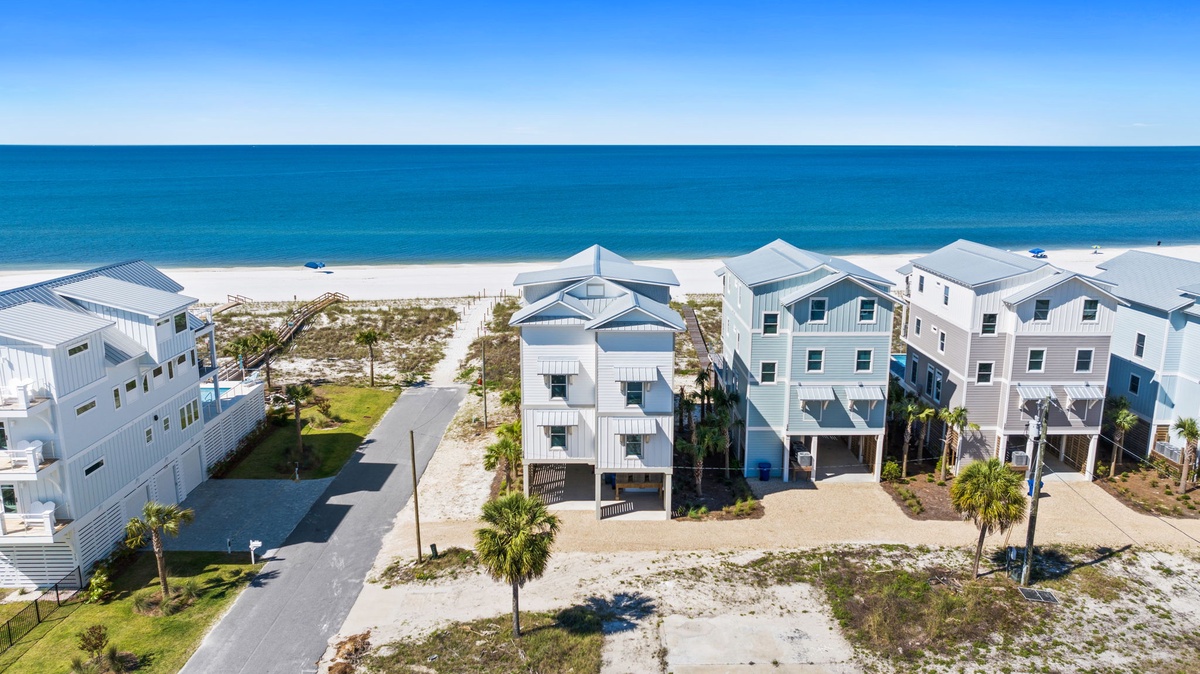 Coastal neighborhood featuring modern beach homes with Gulf of Mexico access. Sandy shores and turquoise waters create a pristine beachfront setting for a relaxing seaside getaway.