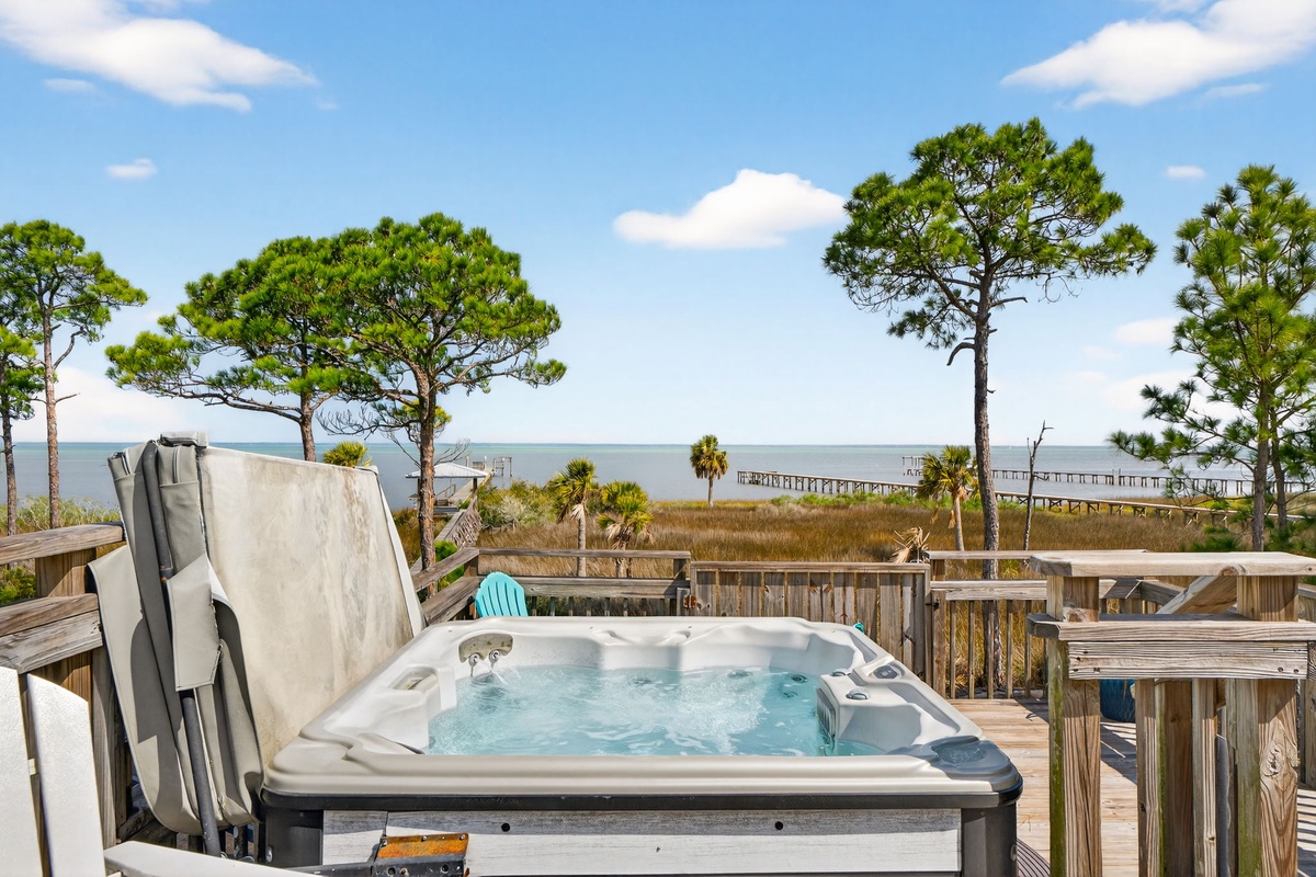 Soak in bubbling waters while coastal breezes carry the sound of waves. Your private hot tub frames stunning marsh and pier views.
