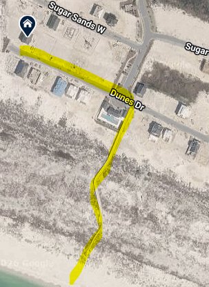 Aerial view shows the property's location near pristine beach with community boardwalk connecting to the sandy shore.