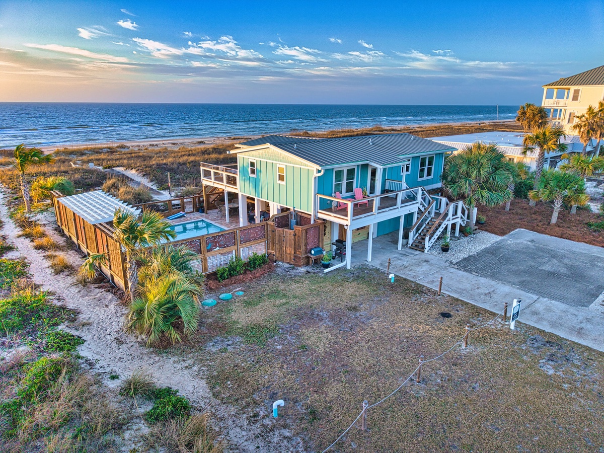 Stunning beachfront property featuring elevated coastal home with private pool and direct beach access on pristine shoreline.