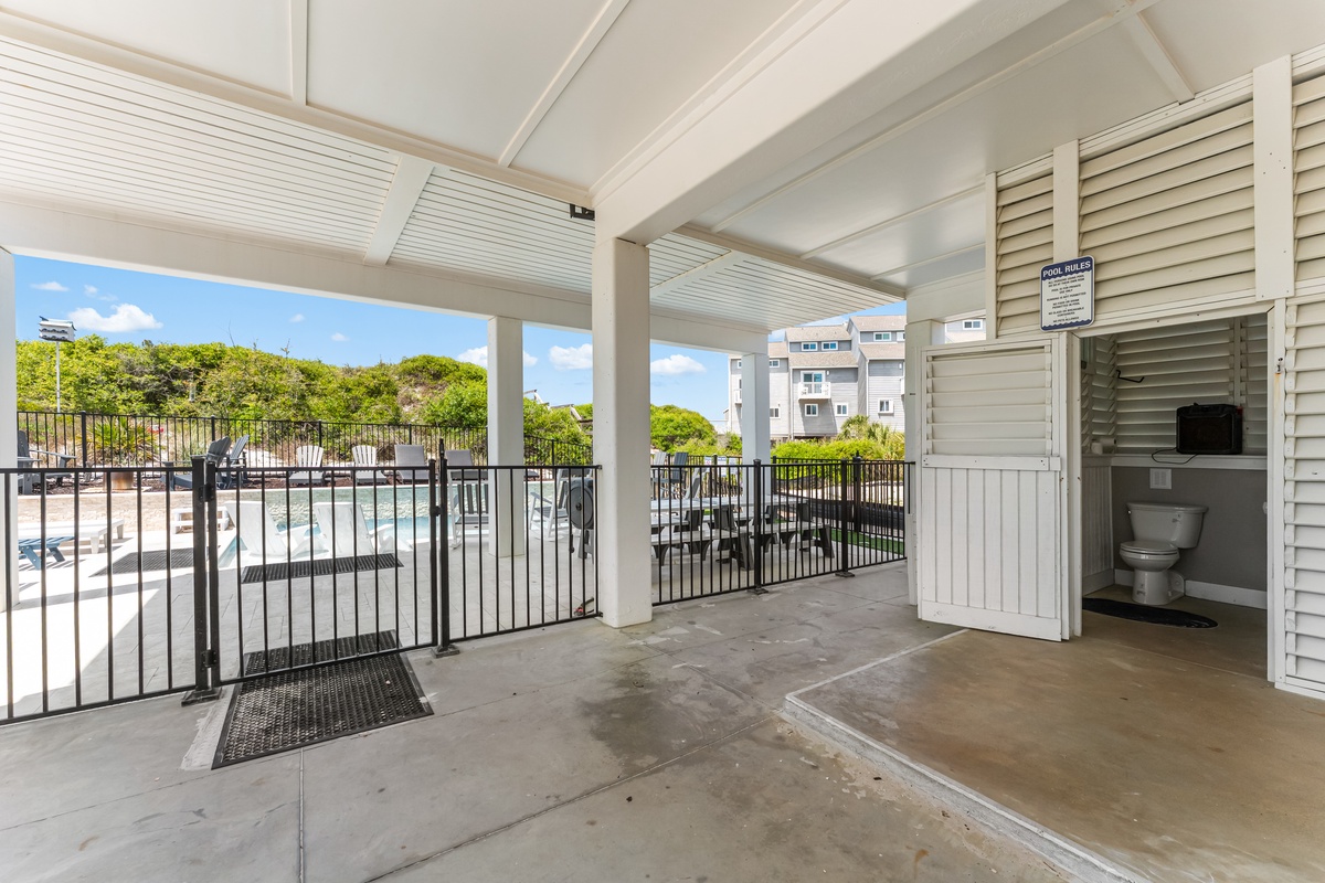 Covered poolside cabana with private bathroom access and pool views for your convenience.