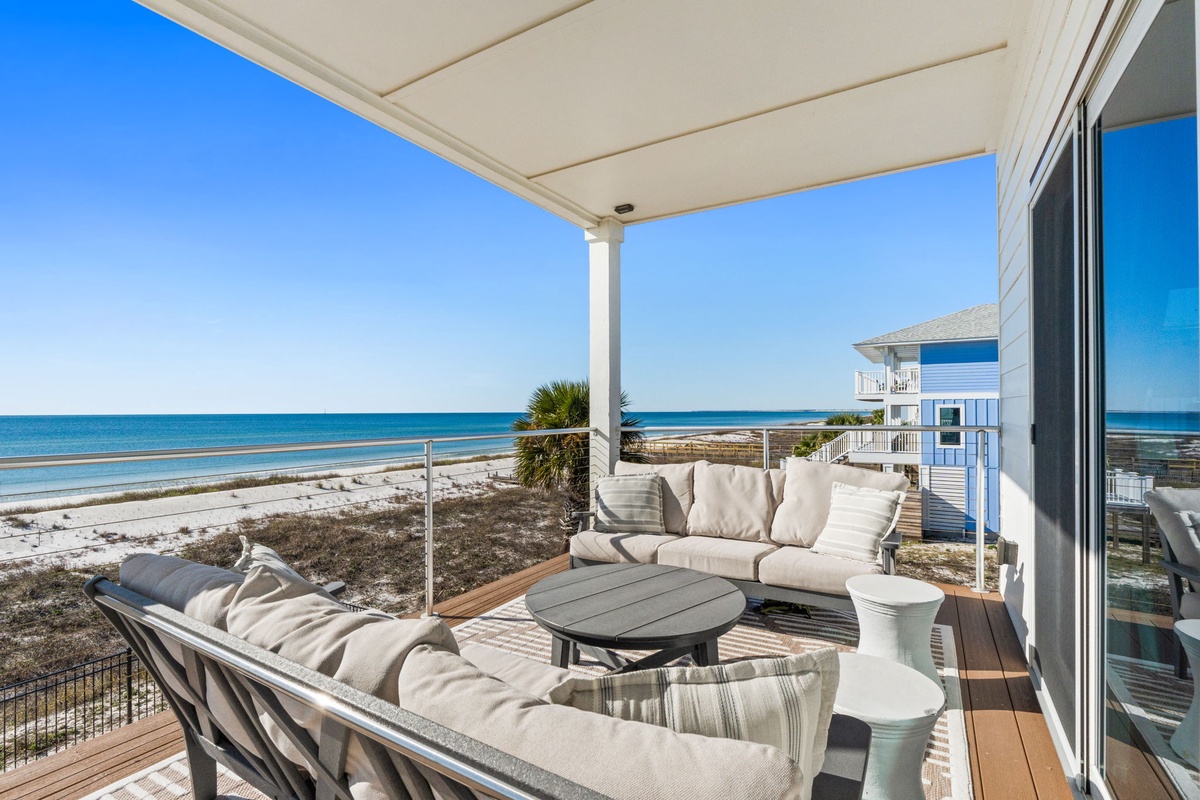 Unwind on your private beachfront terrace with panoramic ocean views, plush seating, and the soothing sound of waves just steps away.