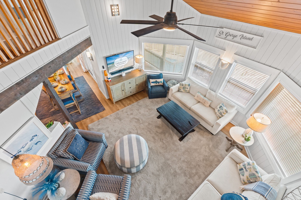 Sink into coastal comfort in this airy living space—soft textures, natural light, and soothing blues invite you to unwind and feel at home.