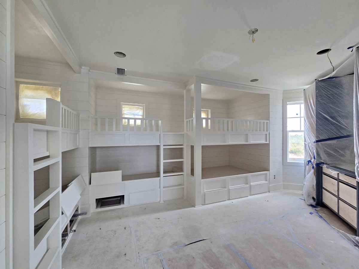 Your spacious bedroom features custom built-in bunk beds with cozy sleeping nooks, perfect for family stays or group getaways.