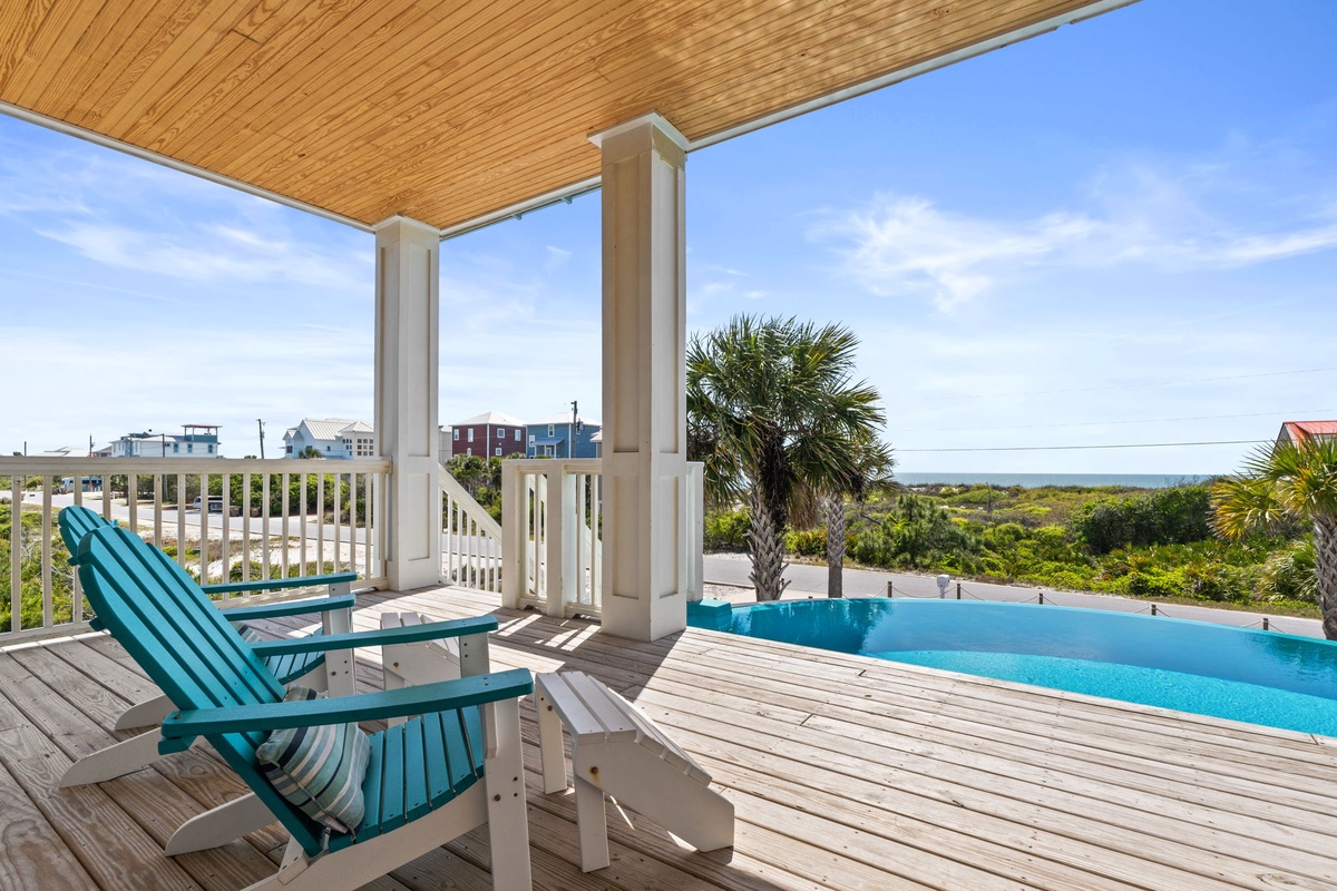 Relax in comfortable deck chairs on your private covered terrace, where the infinity pool meets stunning ocean views.