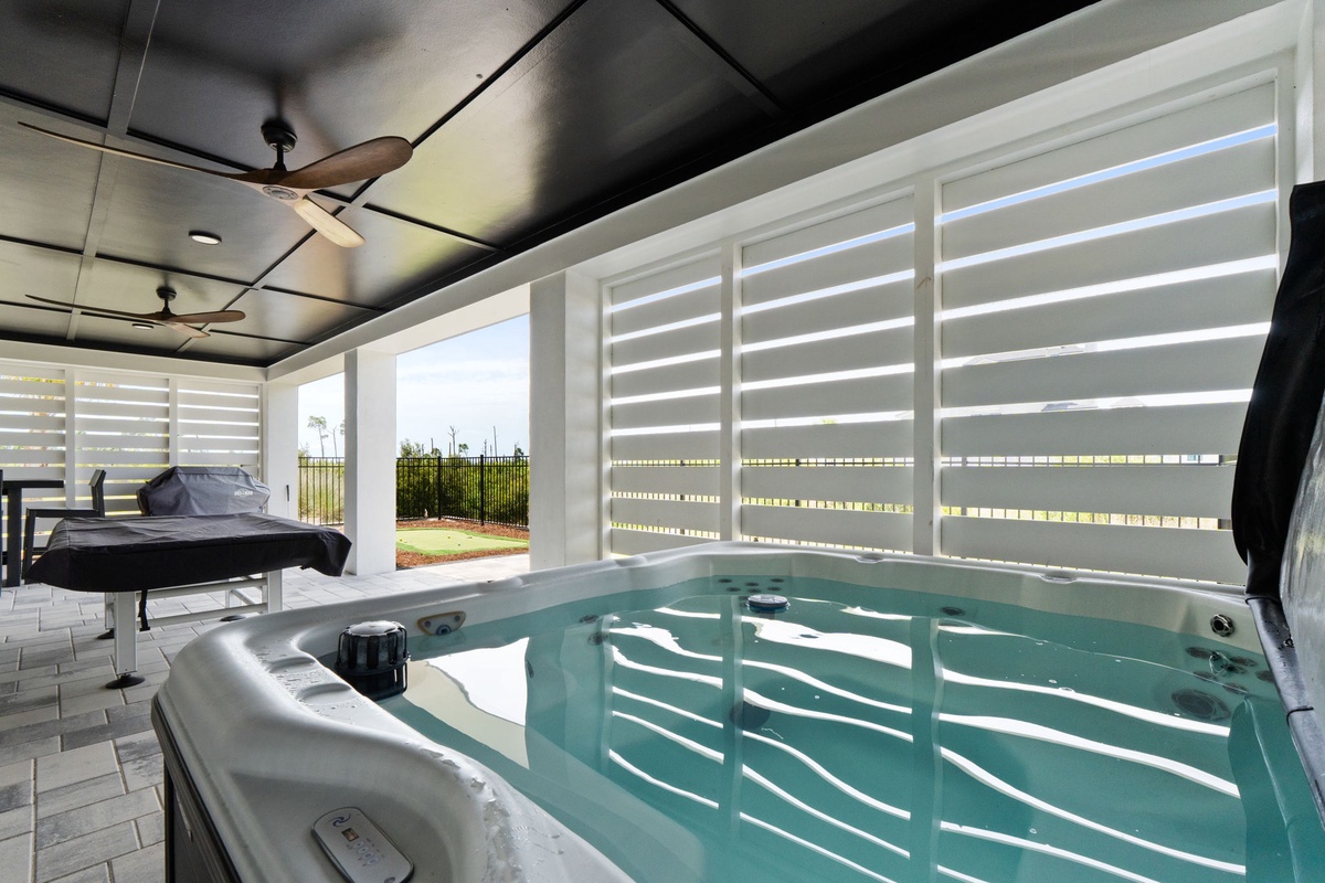 Your private hot tub sanctuary awaits under a dramatic black ceiling, with soft fans and warm light creating a soothing escape where you can unwind and watch the day unfold outside.