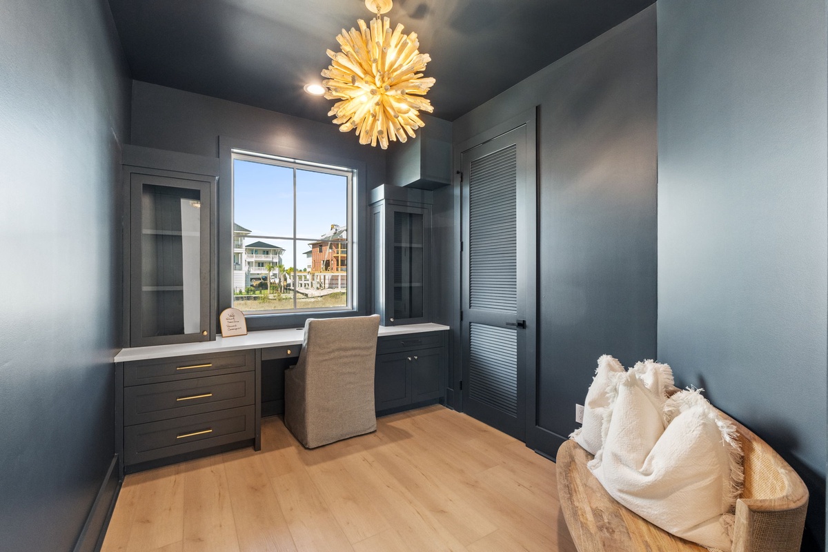 Your private office space features elegant built-in storage and a stunning chandelier, perfect for productive work sessions.