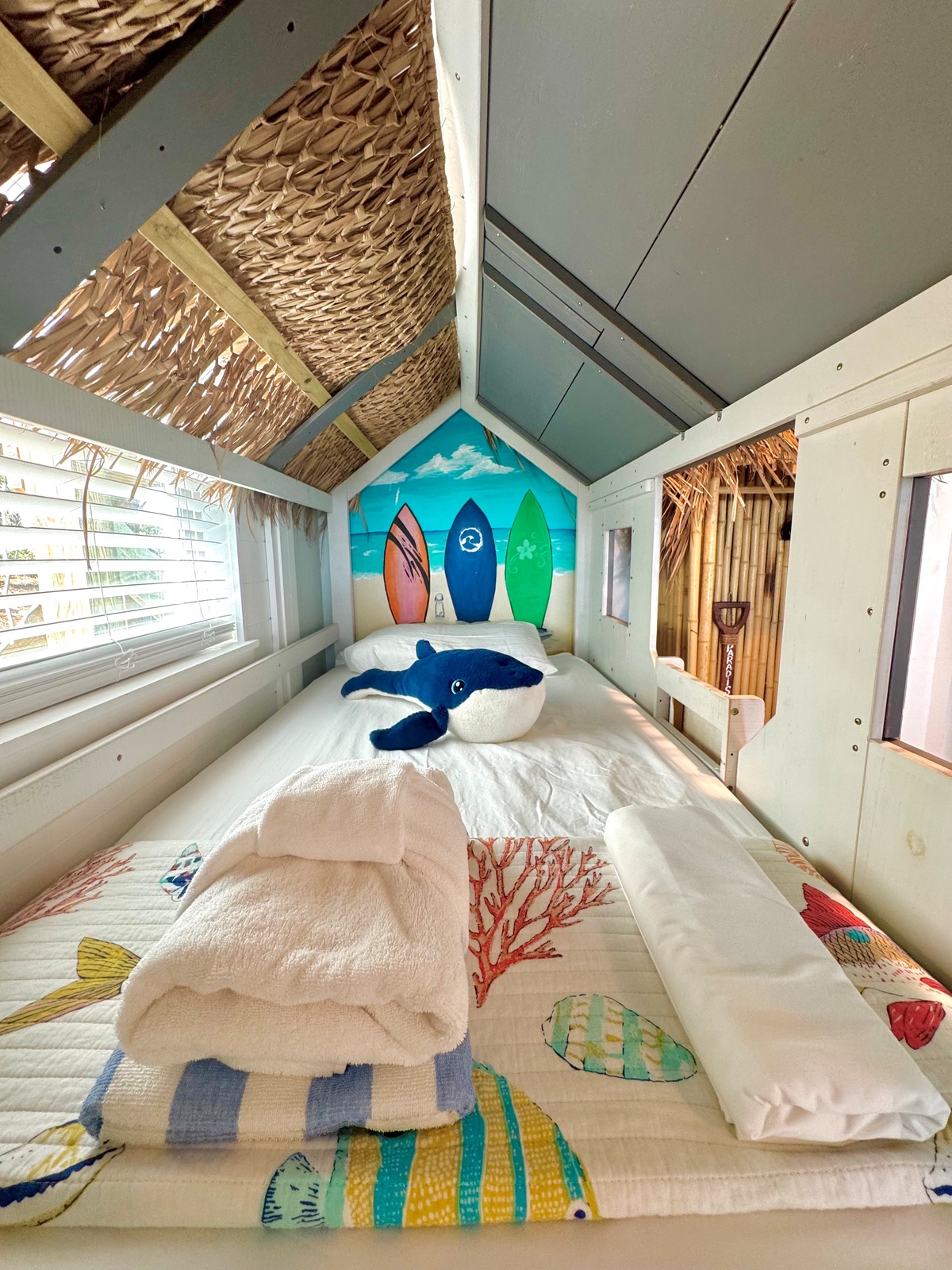 Your cozy beach-themed bed awaits with playful whale friends and surfboard art creating the perfect seaside dreams.