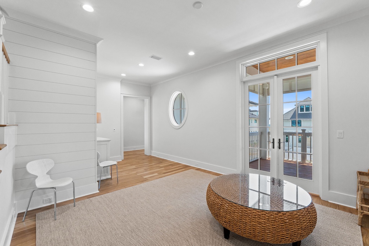 Step into your bright, airy living space where coastal charm meets modern comfort. Natural light floods through French doors opening to your private balcony—perfect for morning coffee or evening relaxation.