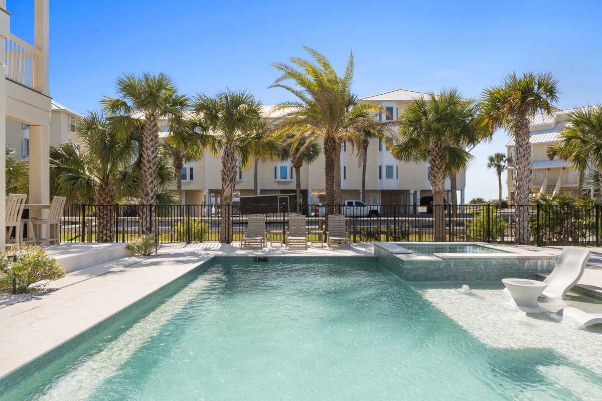 Beautiful resort-style pool area with tropical palms and modern coastal architecture.