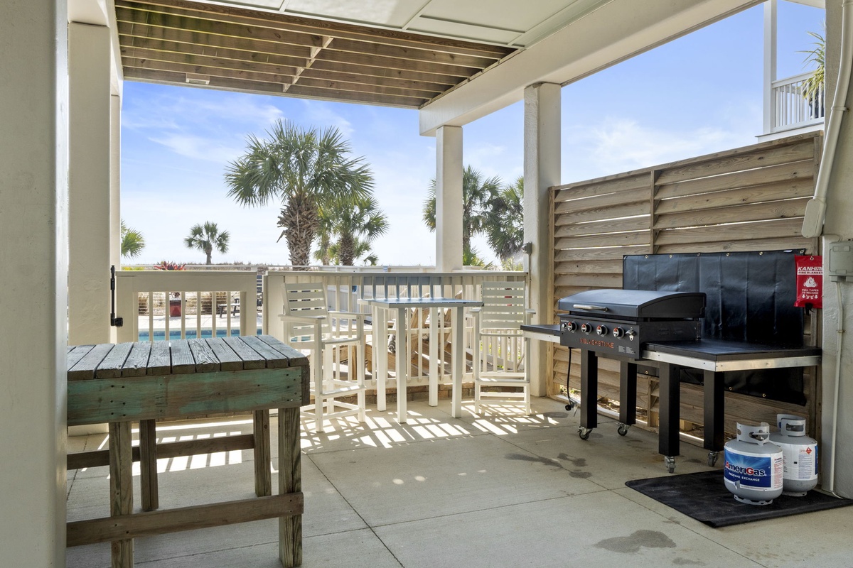 Fire up the grill on your private balcony while tropical palms sway in the distance—perfect for sunset barbecues.