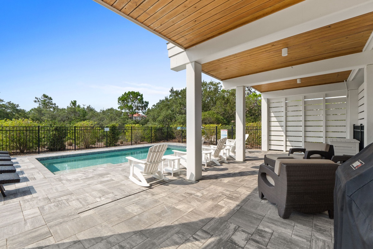 Relax by your private pool under the elegant wood-beamed patio. Lounge on Adirondack chairs, sink into plush outdoor seating, or fire up the grill—your perfect sun-soaked retreat awaits.