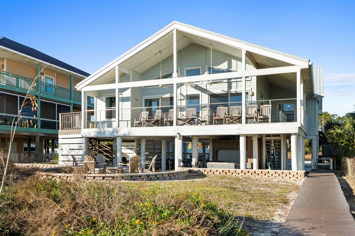 Modern beach house with spacious decks and contemporary design, situated in a peaceful coastal neighborhood.
