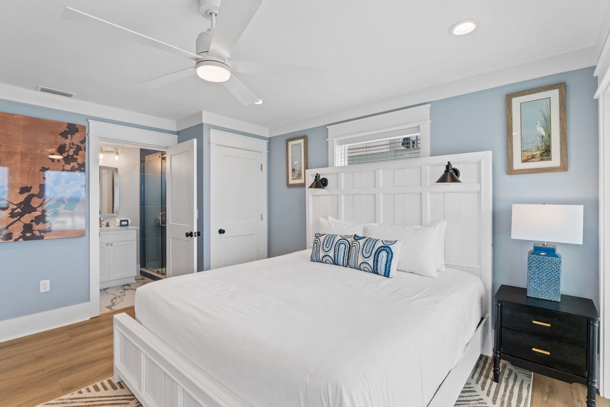 Slip into crisp, white linens and unwind in this serene coastal bedroom. The soothing blue walls and charming nautical touches create a peaceful retreat where you can truly relax and recharge.