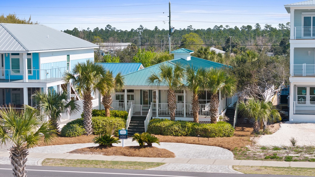 Charming coastal neighborhood with colorful beach houses and swaying palms creates the perfect tropical getaway setting.