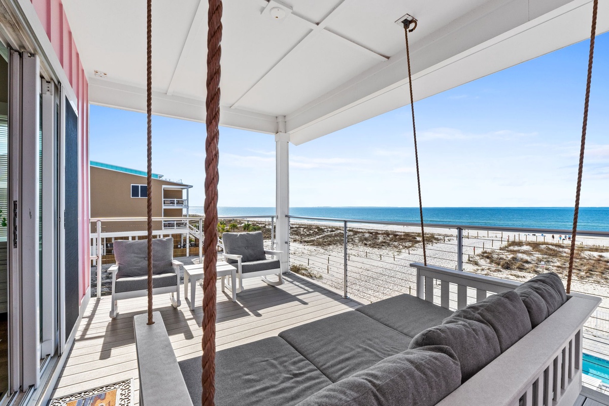 Sway gently on your private porch swing while watching waves roll onto pristine sand below—pure coastal bliss awaits.