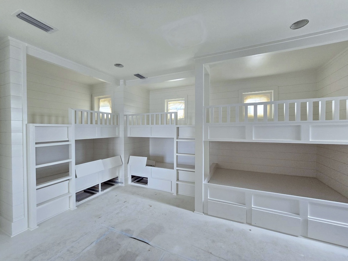 Your kids will love this custom bunk room with built-in storage and cozy sleeping nooks for the perfect sleepover adventure.