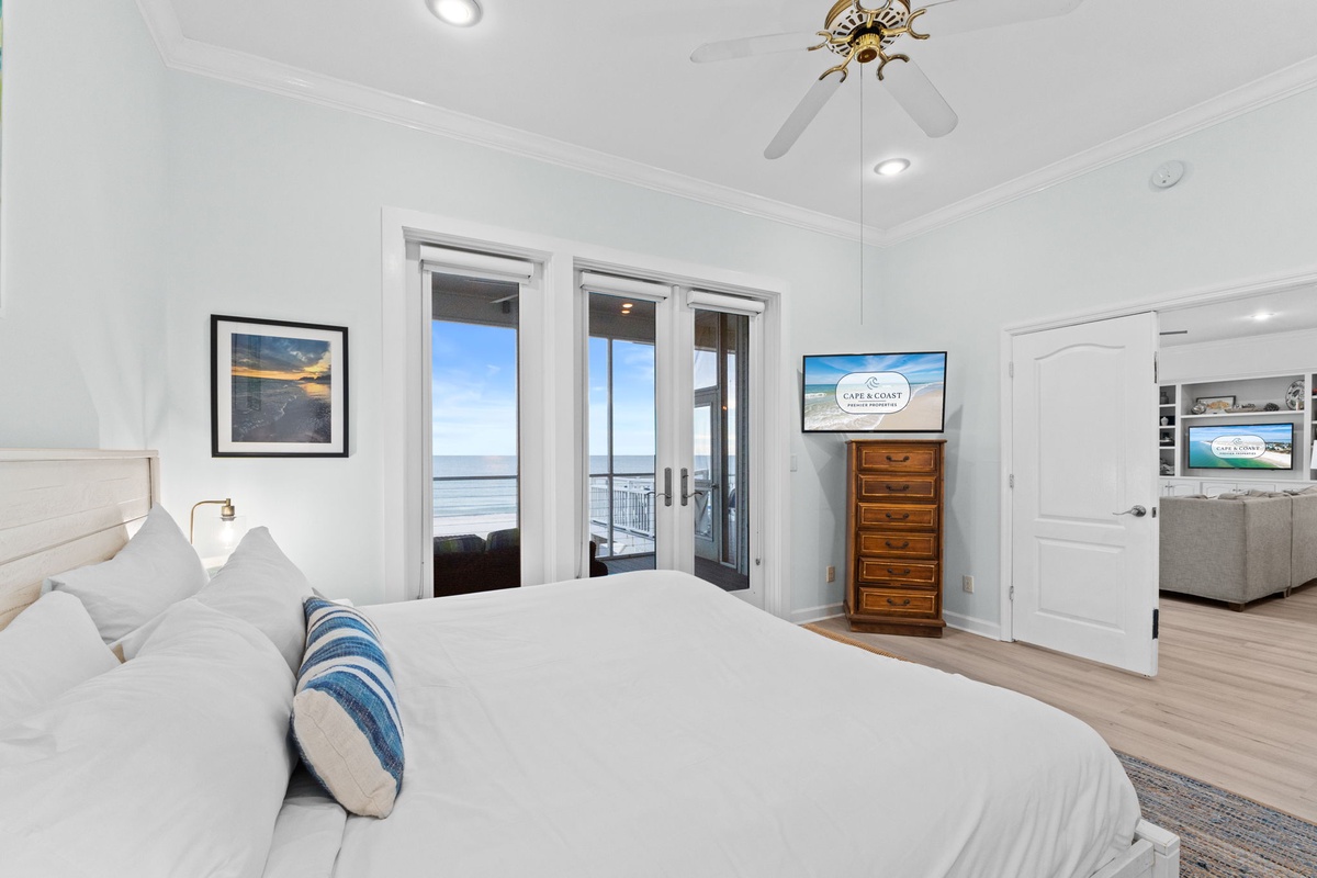 Wake up to stunning ocean views from your bright, peaceful bedroom with direct balcony access and crisp white linens.