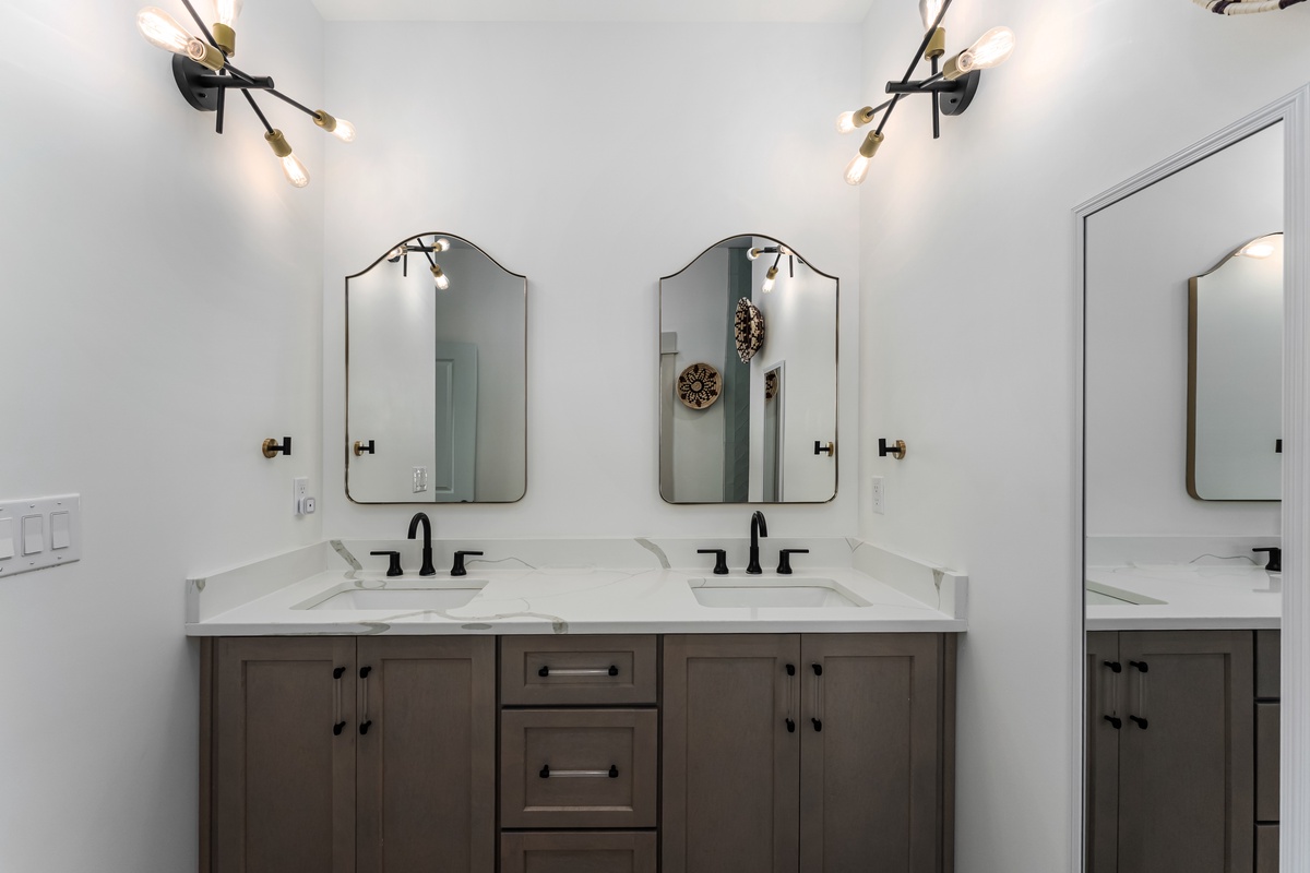 Your elegant master bathroom features dual vanities with marble countertops, perfect for your morning routine together.