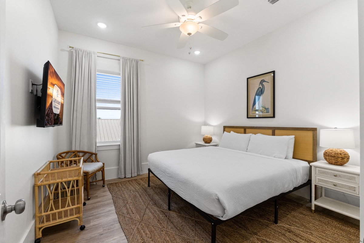 Unwind in your bright, modern bedroom with crisp white linens, natural accents, and a cozy reading chair for peaceful moments.