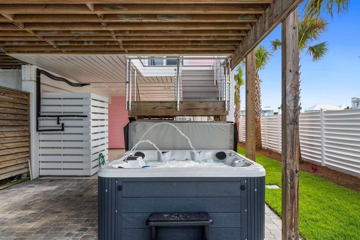 Soak away your cares in your private hot tub, surrounded by tropical palms and sunny skies—pure relaxation awaits in your outdoor sanctuary.